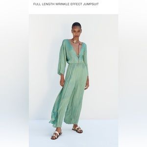 BRAND NEW W/TAGS. Flowy with adjustable tie in back and detail at front.